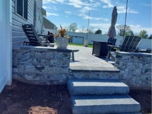 Backyard patio with stone wall and outdoor seating area
