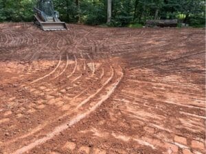 Graded backyard soil prepared for seeding or landscaping installation