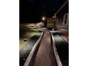 Lighted curved walkway and landscape edging at night