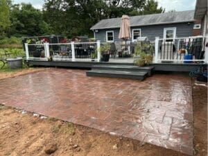 Stamped concrete patio with outdoor seating and deck area