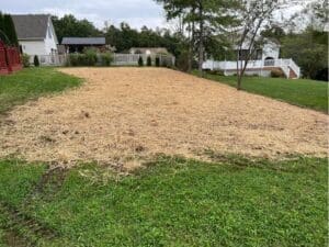 Large yard area prepared with fresh straw for grass seed establishment
