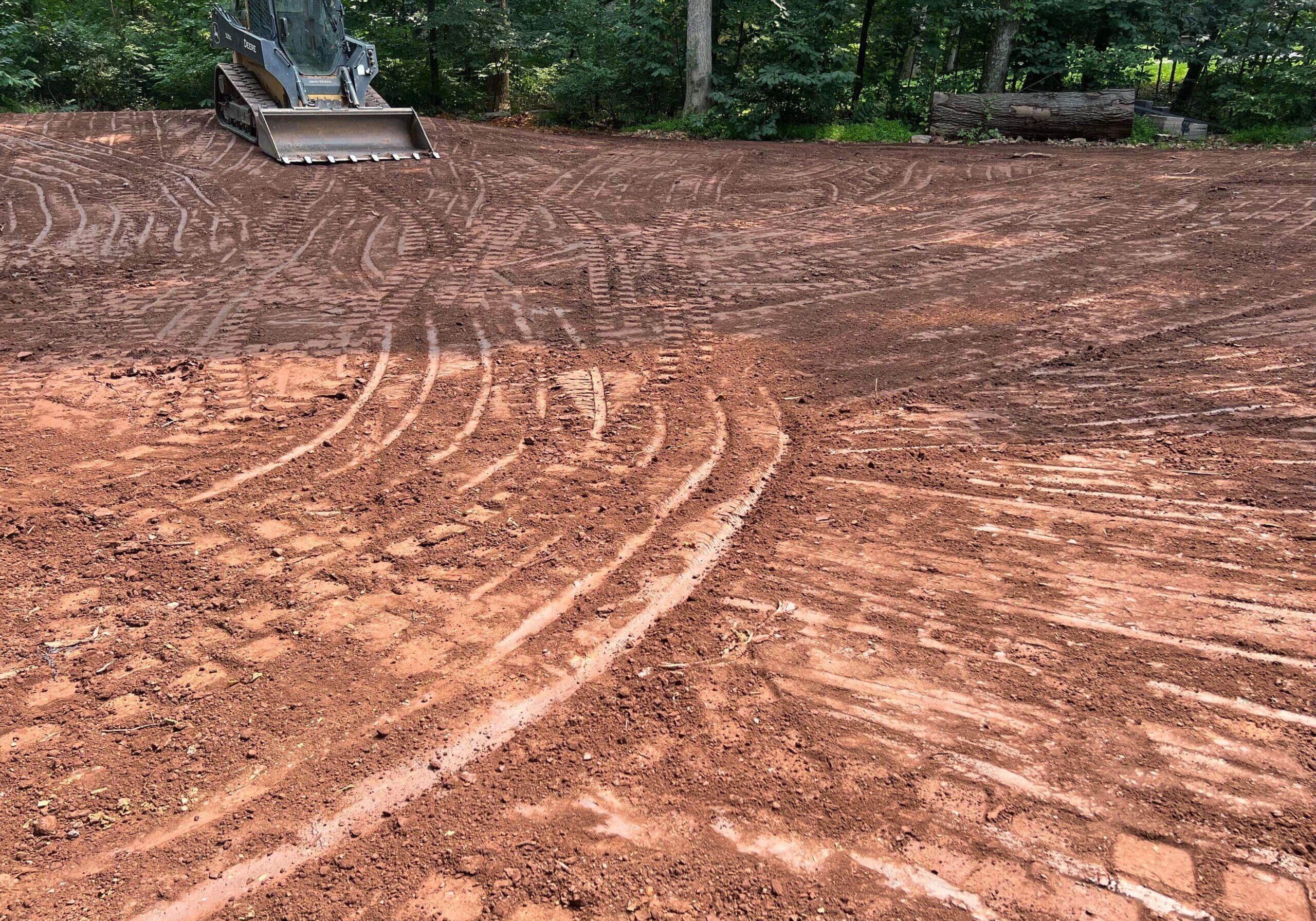 Freshly graded backyard area prepared for landscaping or lawn installation