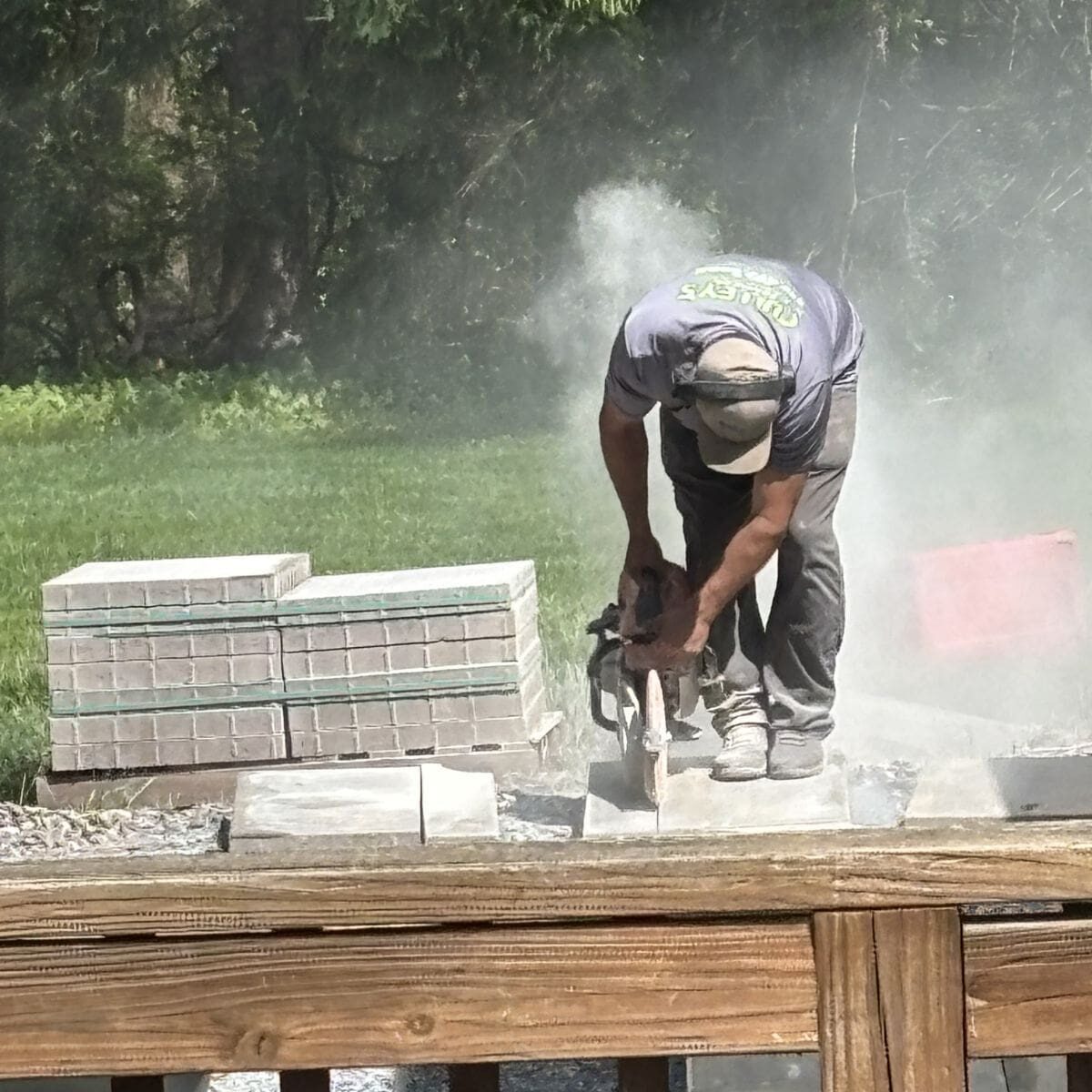 Contractor cutting stone during an outdoor hardscaping project